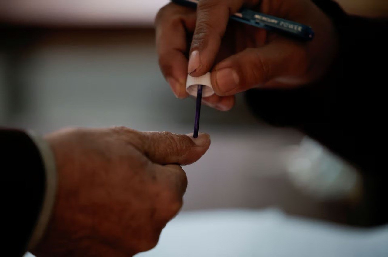 a man gets his finger marked as he arrives to cast his vote at a polling station during the general election in lahore february 8 photo reuters