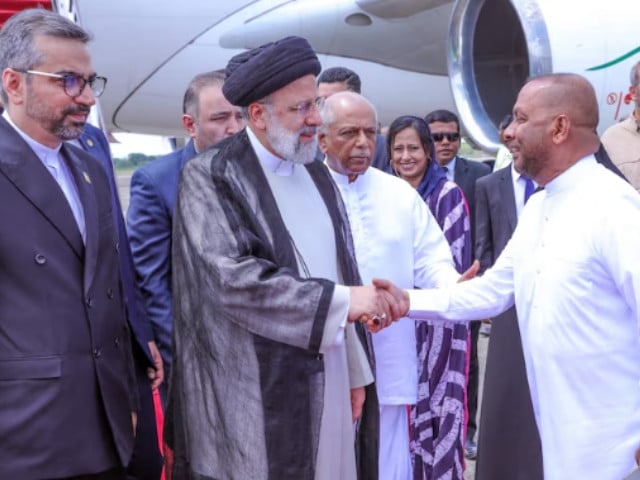 iran s president ebrahim raisi shakes hands with sri lanka s agriculture minister mahinda amaraweera as prime minister dinesh gunawardena looks on upon raisi s arrival at mattala rajapaksa international airport sri lanka april 24 2024 president media handout via photo reuters