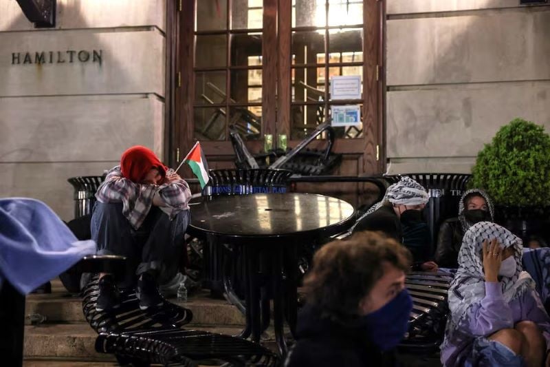 student protesters sit watch outside hamilton hall where students at columbia university continue protesting in support of palestinians barricaded themselves inside the building despite orders from university officials to disband a protest encampment or face suspension during the ongoing conflict between israel and the palestinian islamist group hamas in new york city us photo reuters