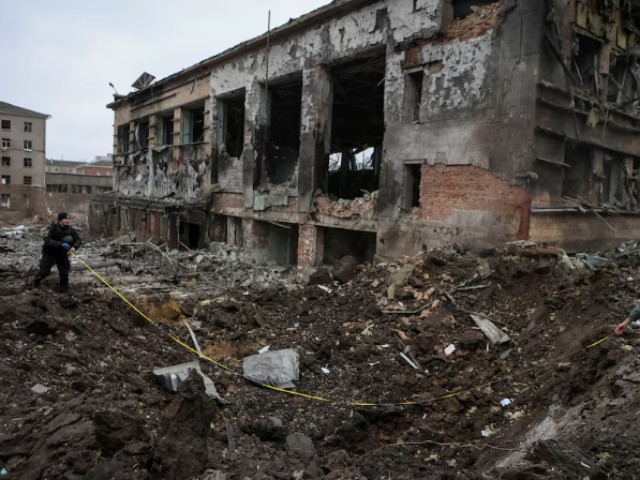 experts inspect a crater next to a building heavily damaged during a russian missile attack amid russia s attack on ukraine in central kharkiv ukraine january 2 2024 photo reuters