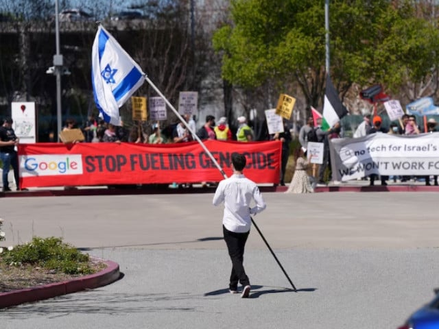 a counter protester holding an israeli flag walks into the parking lot near a protest at google cloud offices in sunnyvale california u s on april 16 2024 photo reuters