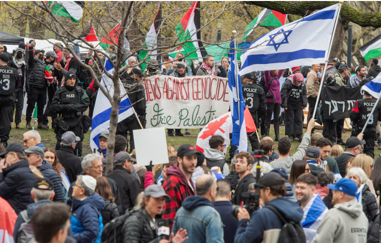 police stand between counter protesters and a protest encampment in support of palestinians during the ongoing conflict between israel and the palestinian islamist group hamas at mcgill university s campus in montreal quebec canada may 2 2024 reuters peter mccabe